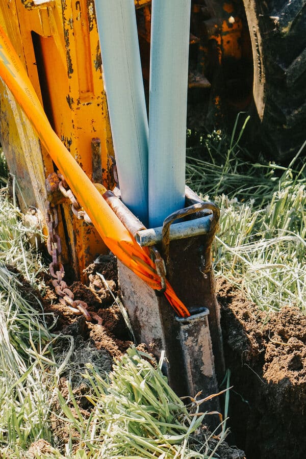 Das Schneidmesser der Pflugmaschine durchtrennt senkrecht den Boden auf einem Feld